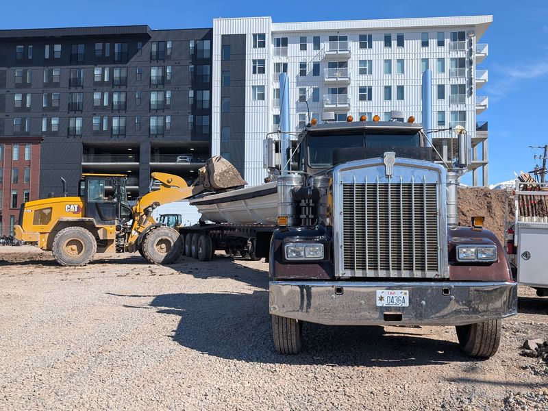 Ironside Dump Trucks Kenworth dump truck being loaded by a CAT excavator at a construction site