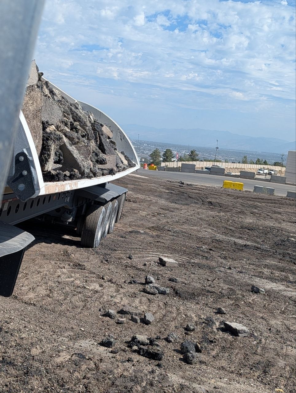 Dump trailer loaded with chunked asphalt for haul-off from a Highland, Utah project
