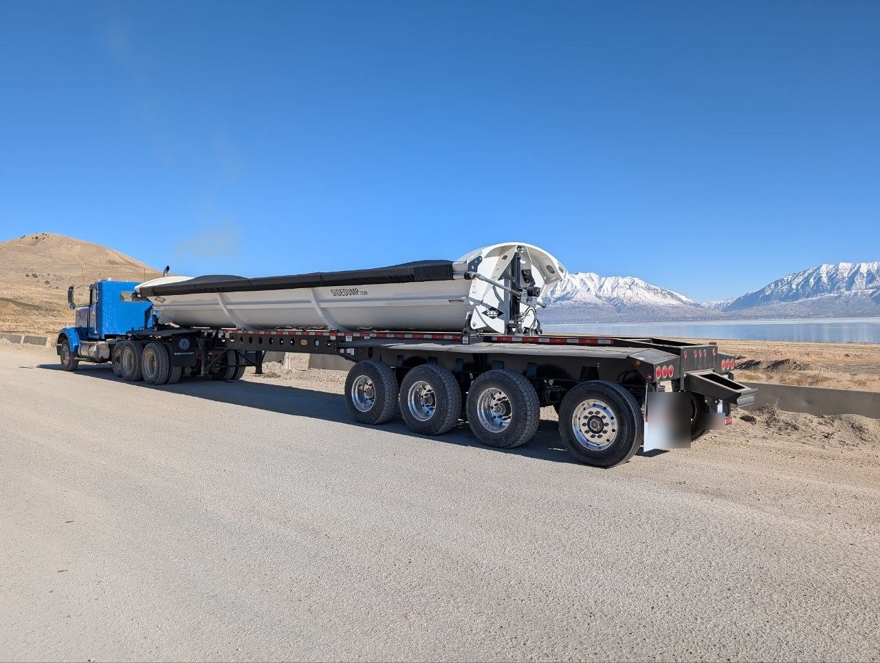 Loaded Ironside 4-axle side dump trailer ready to haul material from a Utah gravel pit